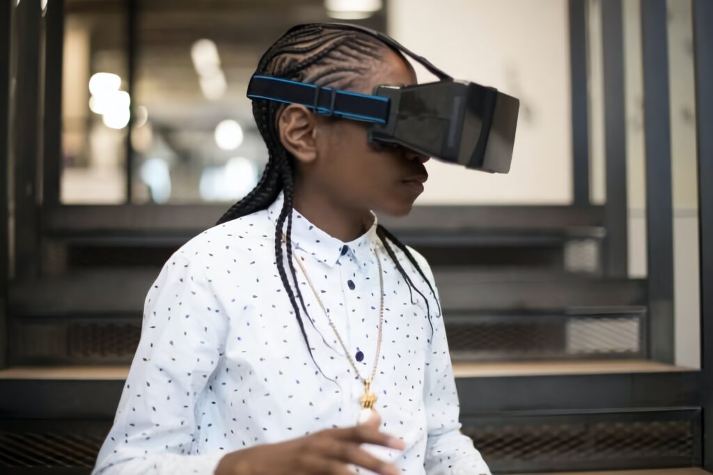 A black person wearing a virtual reality headset exploring the metaverse